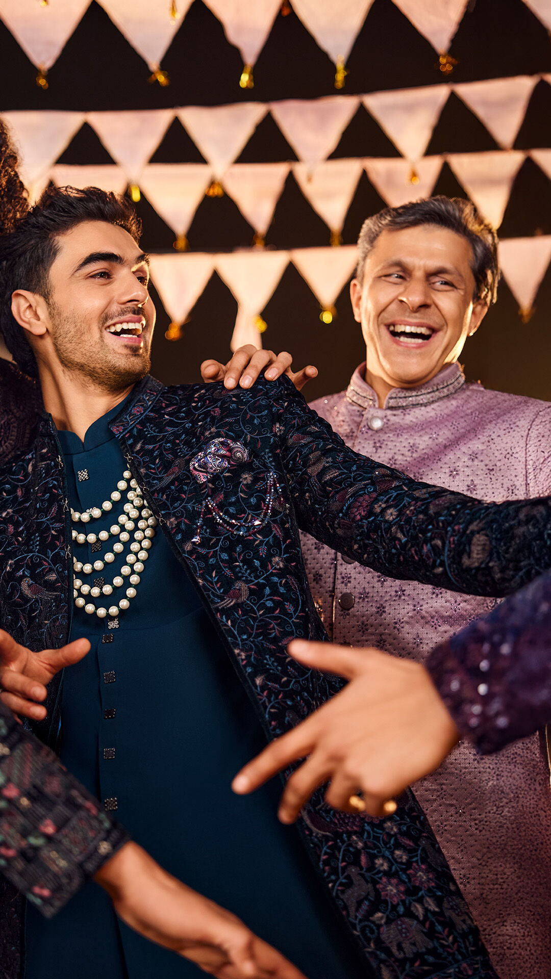 Father and son enjoying wearing elegant sherwanis for perfect wedding look.